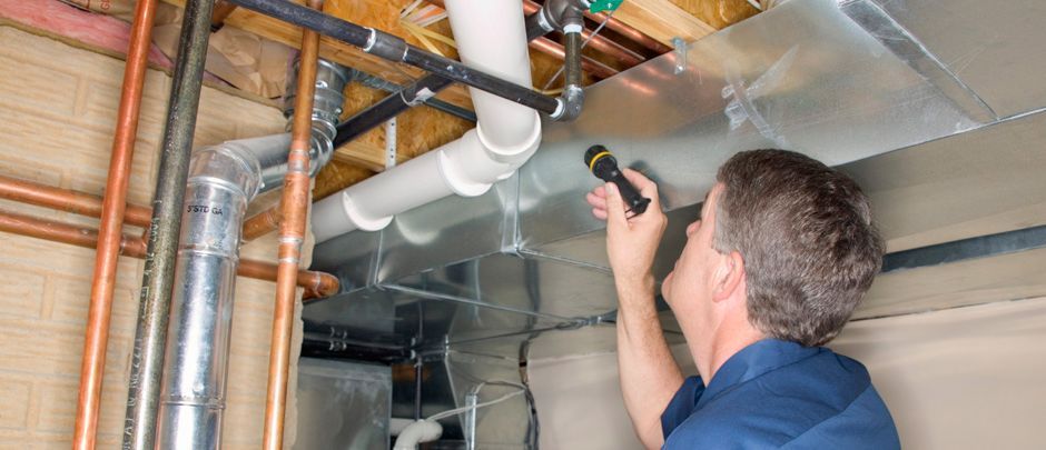 Service Technician inspecting pipes