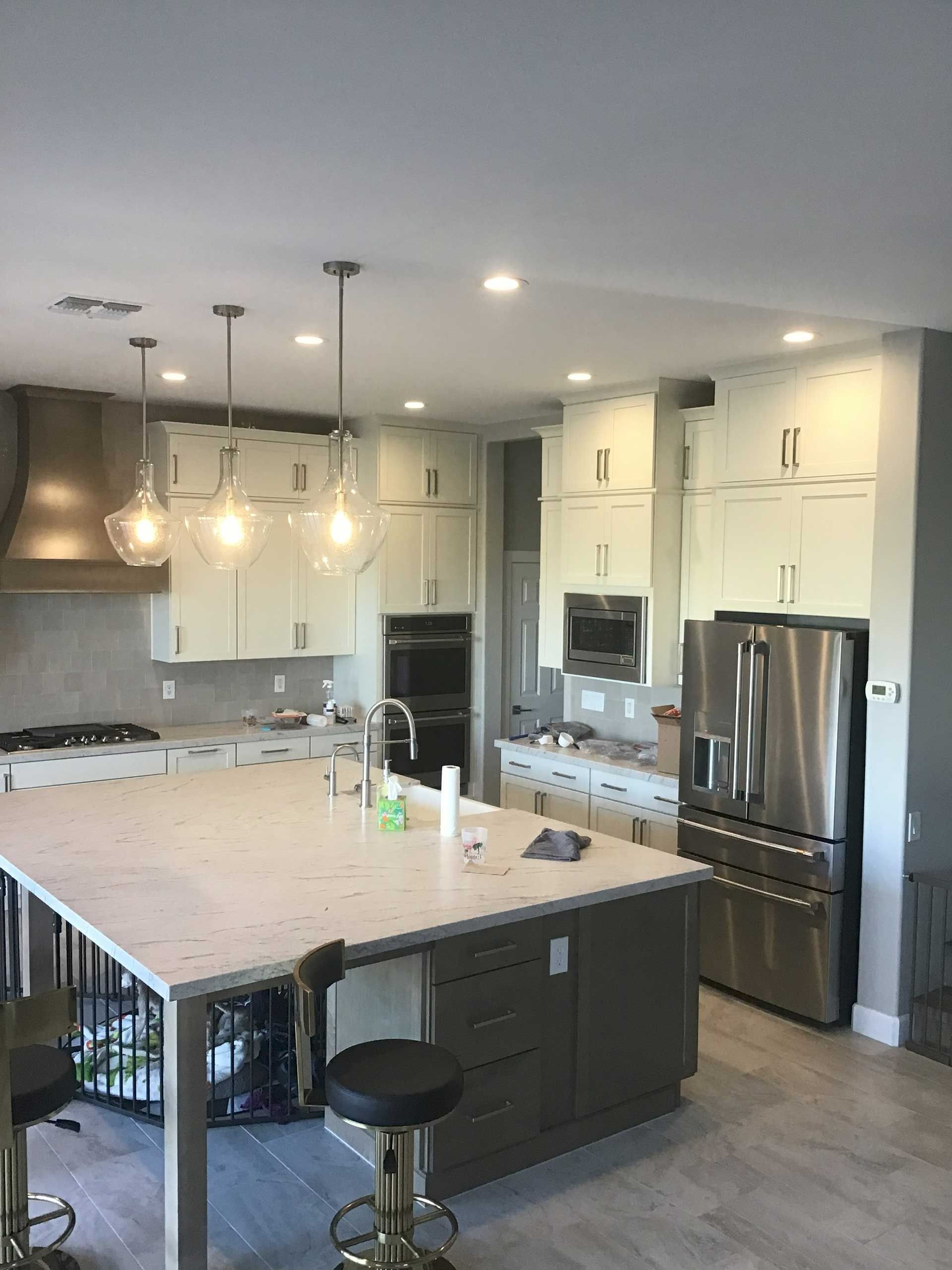 modern kitchen with a large island and white cabinets
