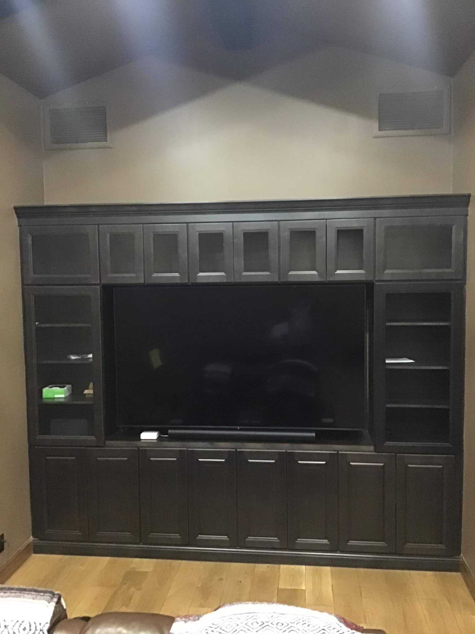 A large entertainment center with a flat screen tv.