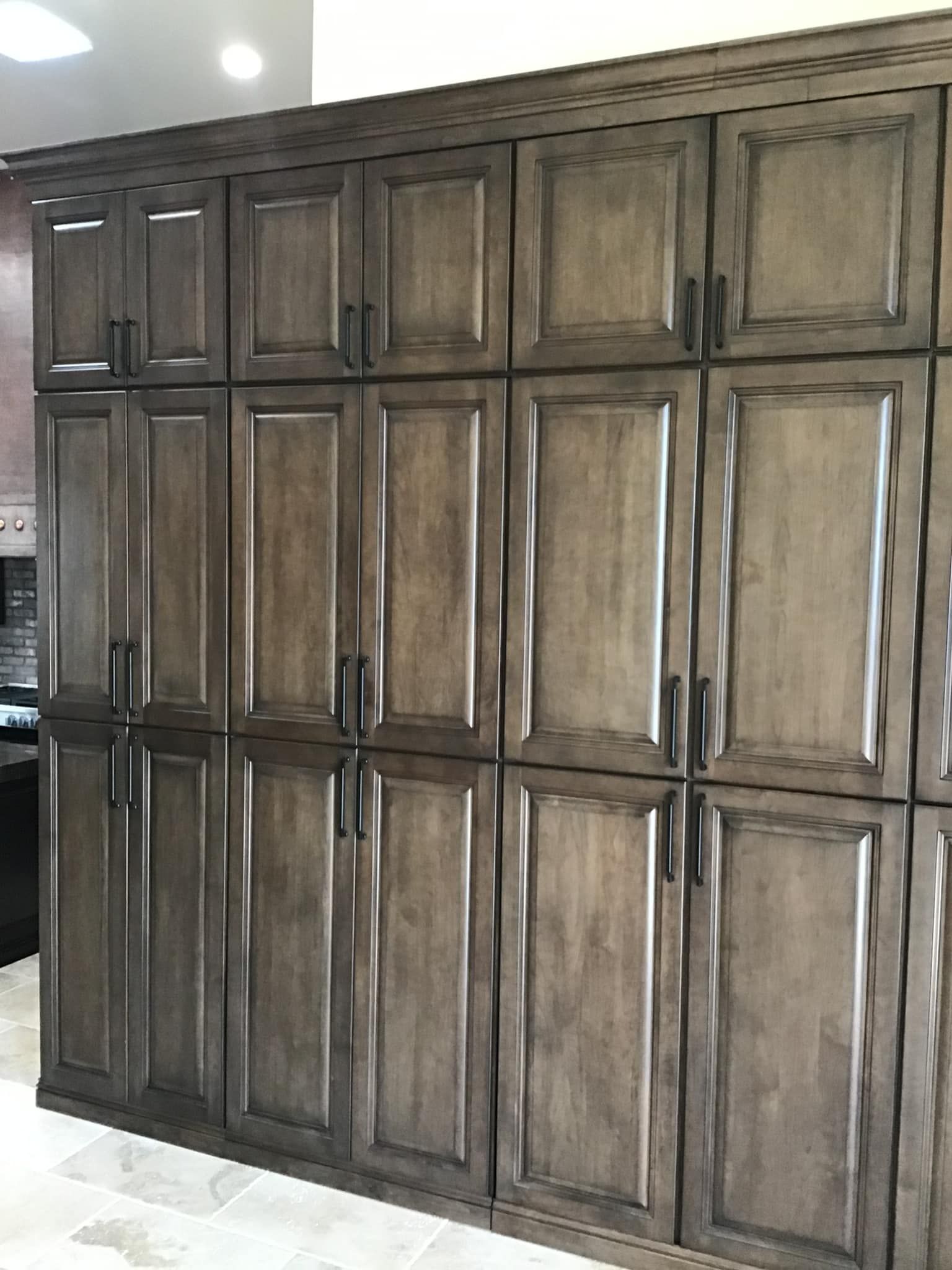 A kitchen with a lot of wooden cabinets and a stove.
