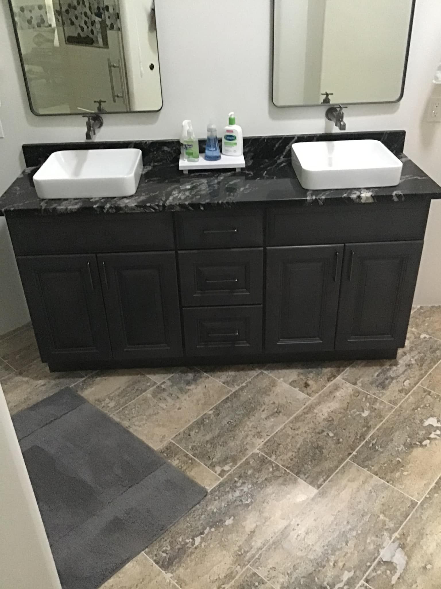 A bathroom with two sinks and two mirrors.