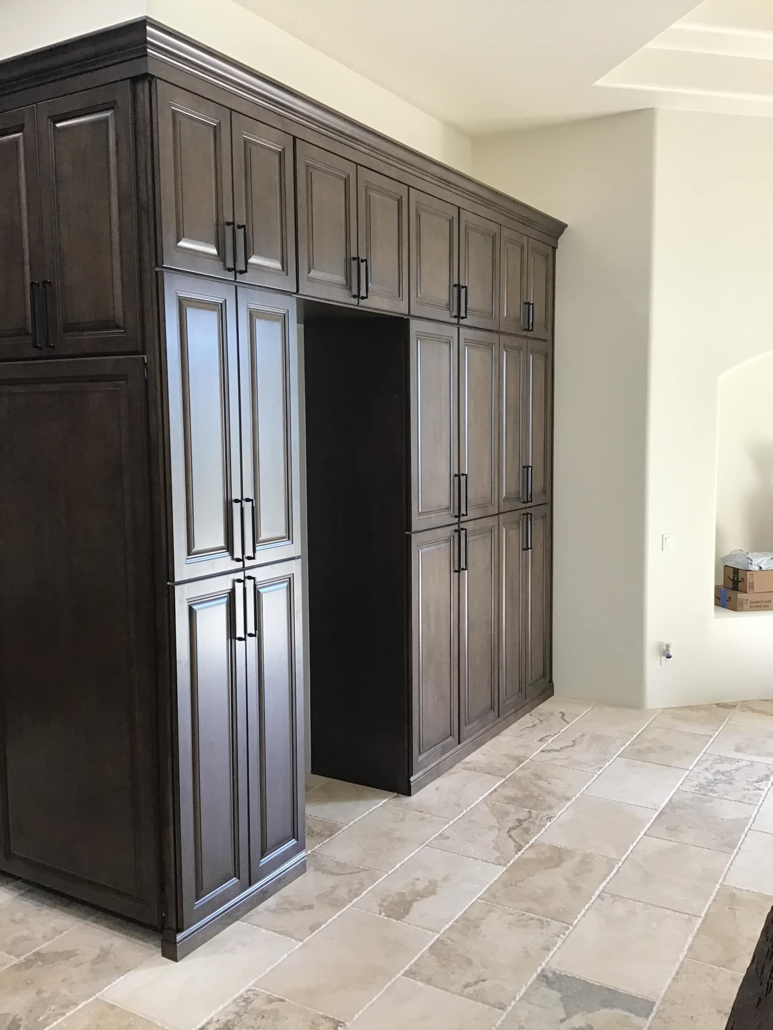 A kitchen with a lot of cabinets and a refrigerator.