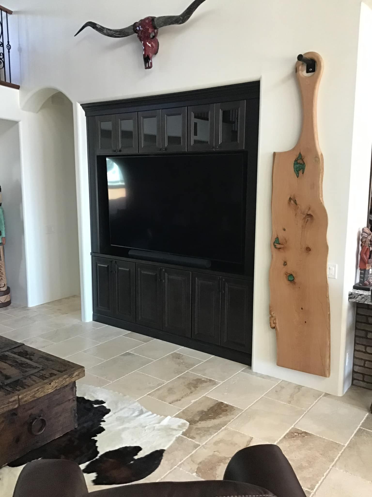A living room with a large flat screen tv on the wall.