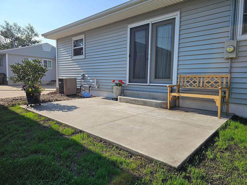 A house with a patio and a bench in front of it