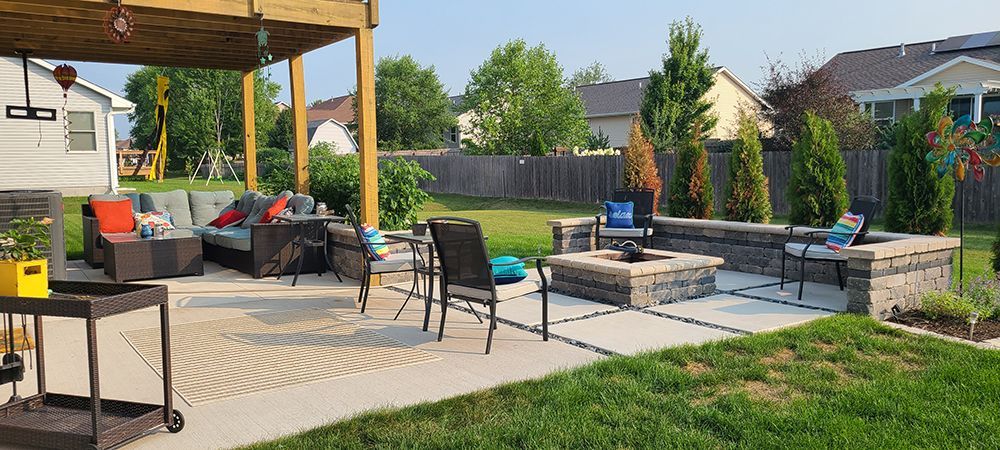There is a fire pit in the middle of the backyard.