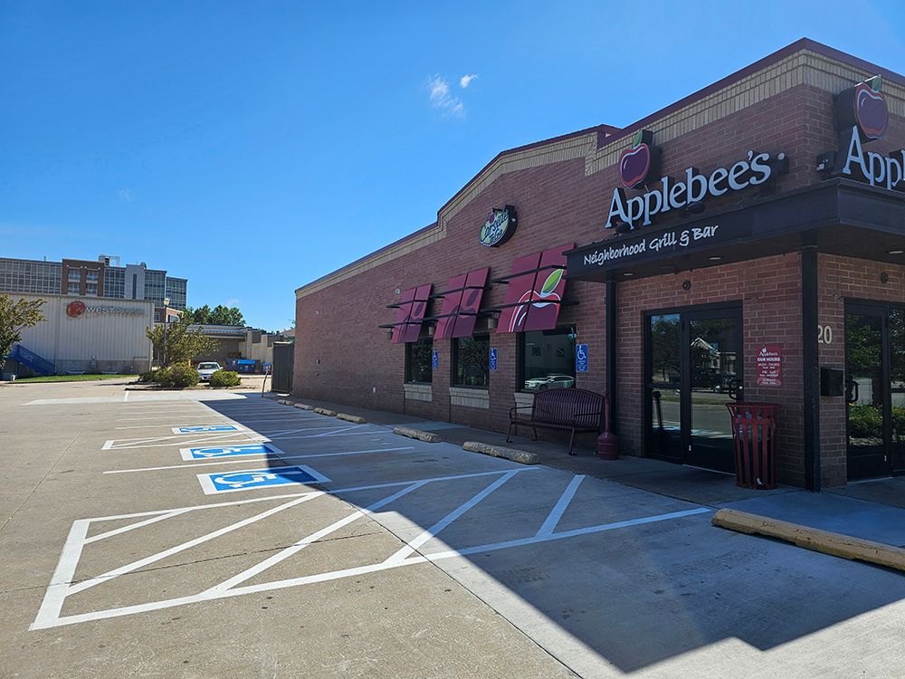 A large brick building with a handicapped parking spot in front of it.