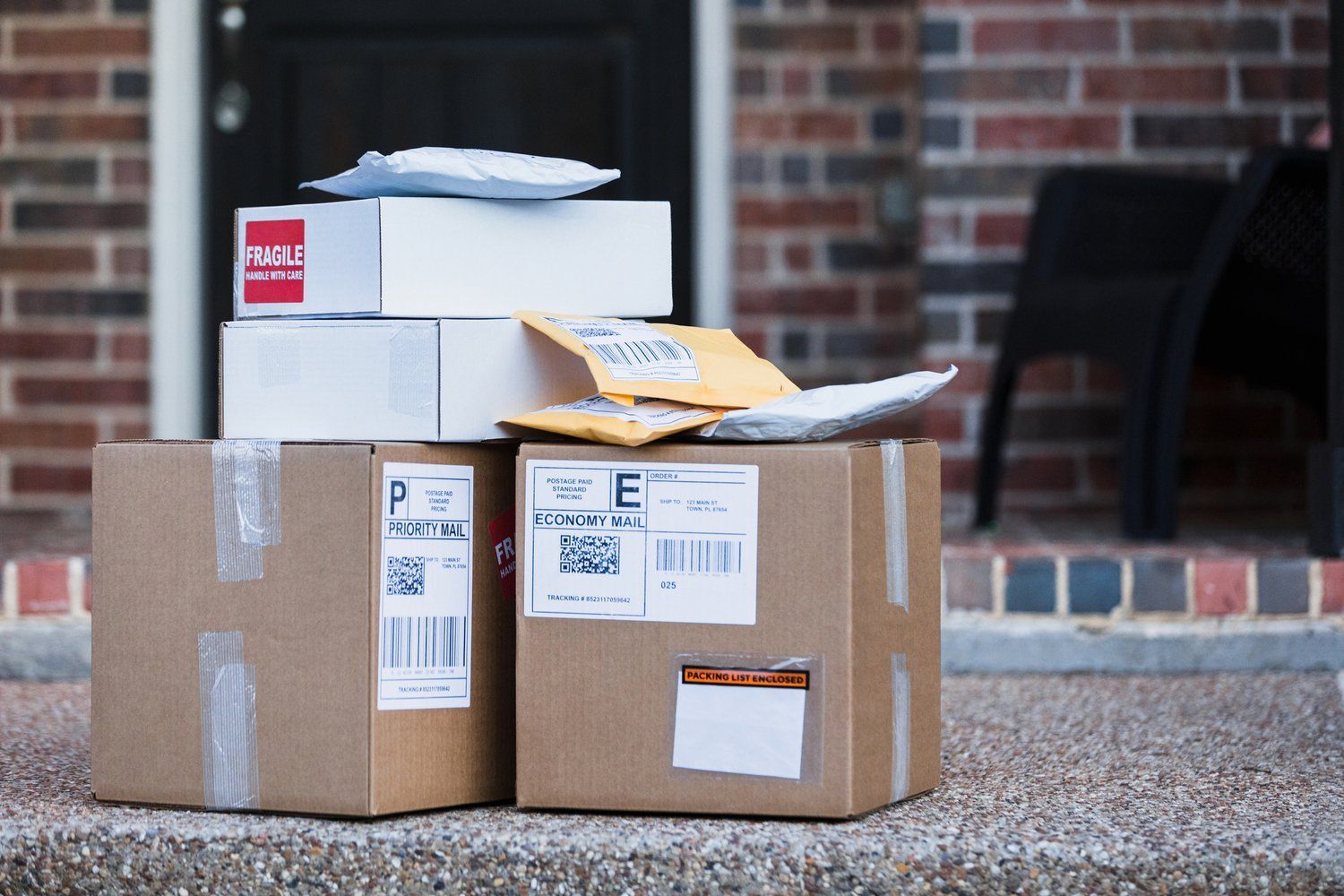 a stack of boxes sitting on a porch in front of a brick building