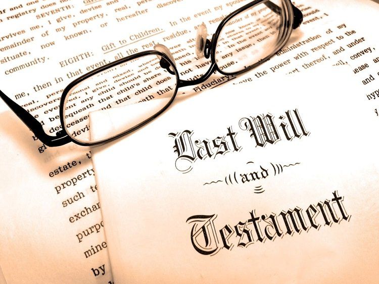 Last Will and Testament document with eyeglasses resting on top of the papers.