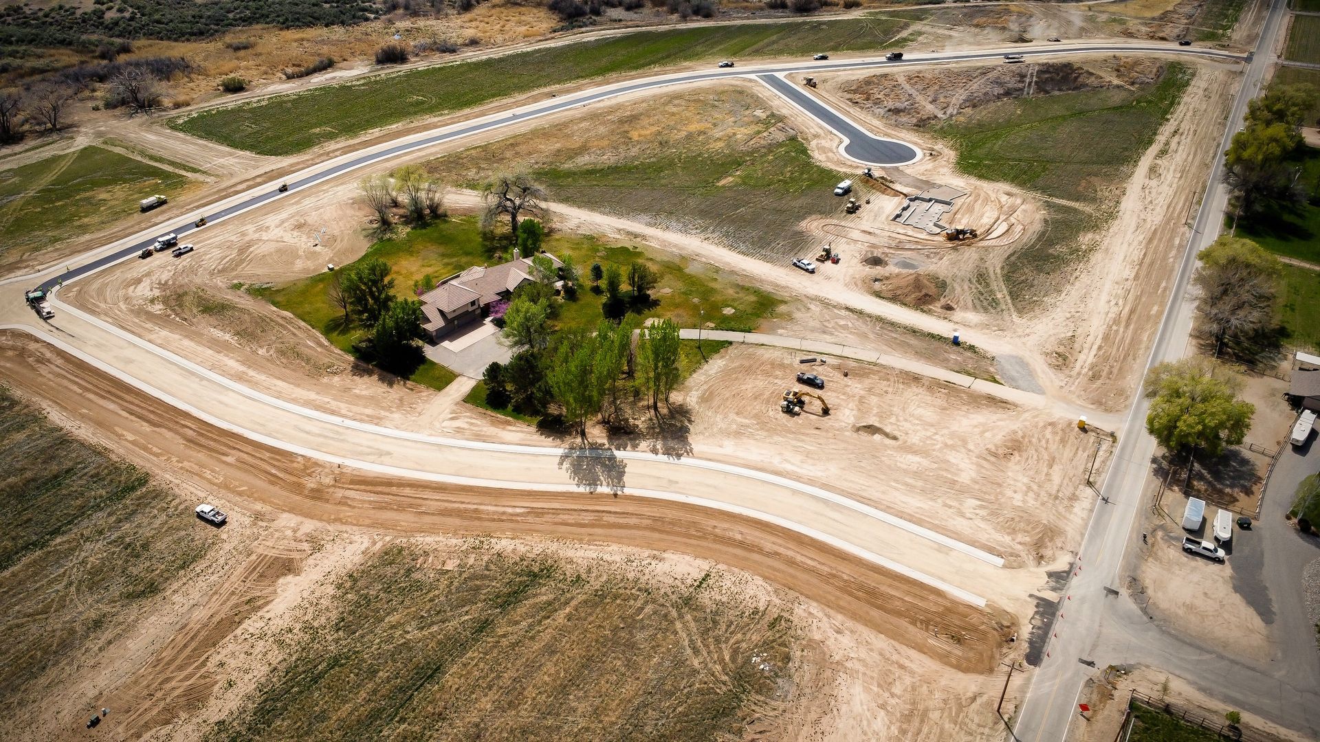 An aerial view of a residential area with a house in the middle of it.