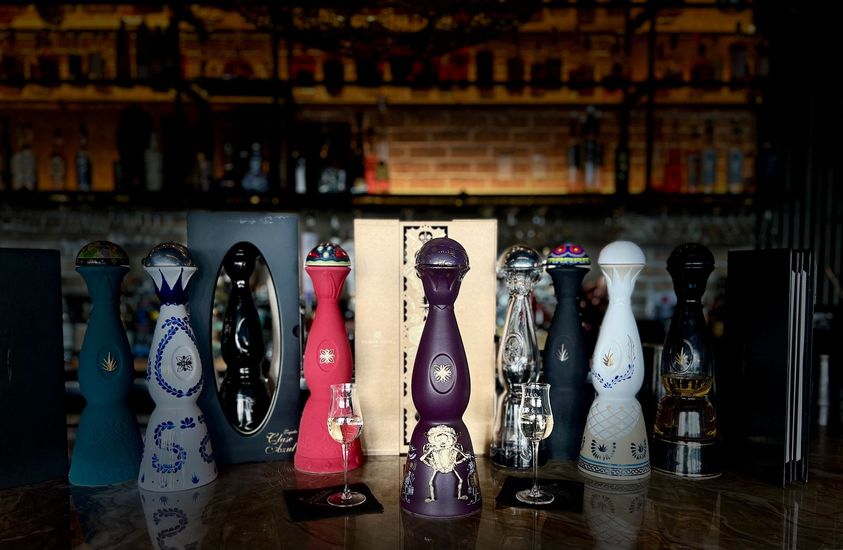 A row of salt and pepper shakers are sitting on a counter.