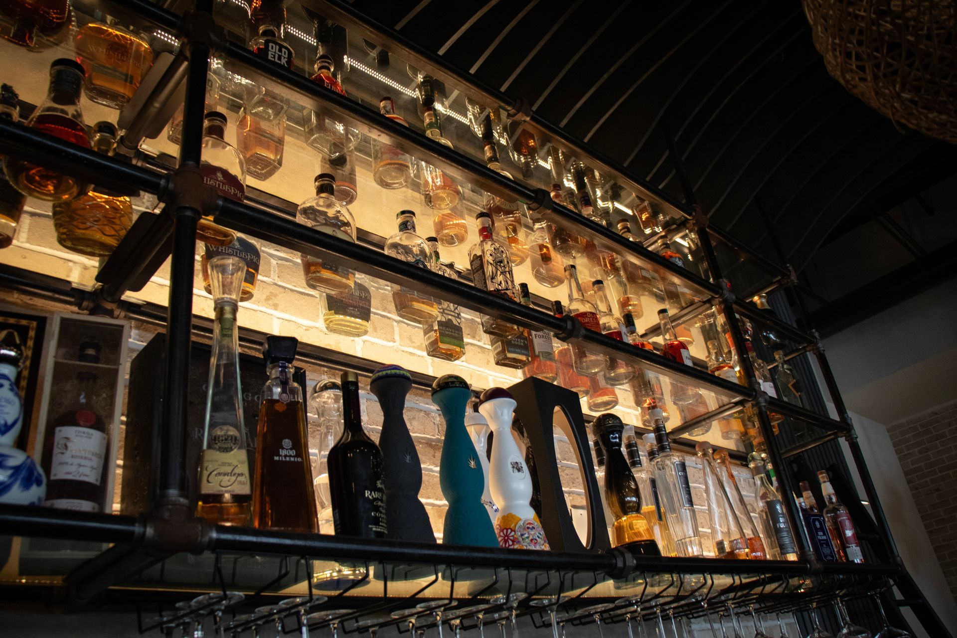A bar filled with lots of bottles and glasses