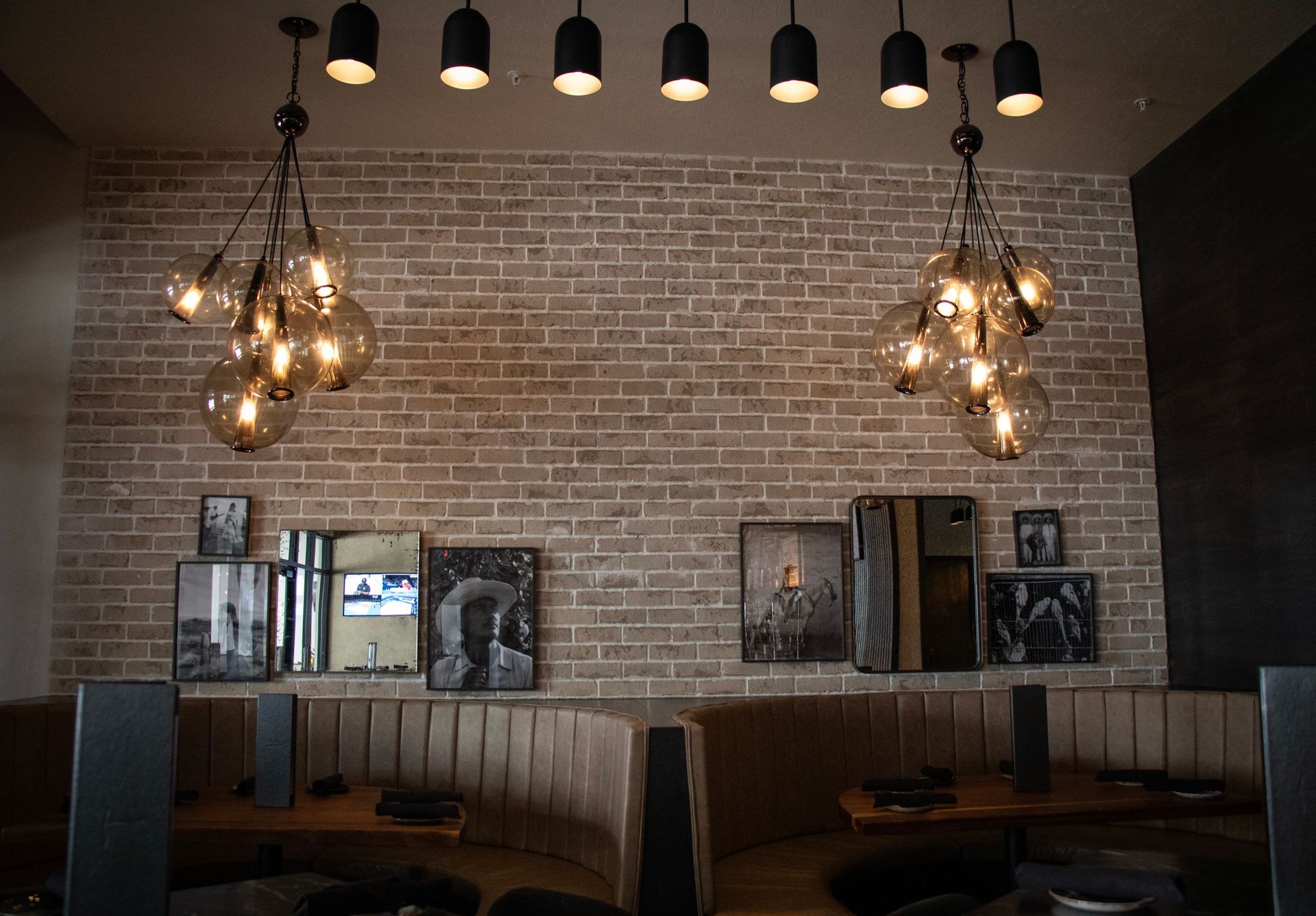 A restaurant with a brick wall and lots of lights
