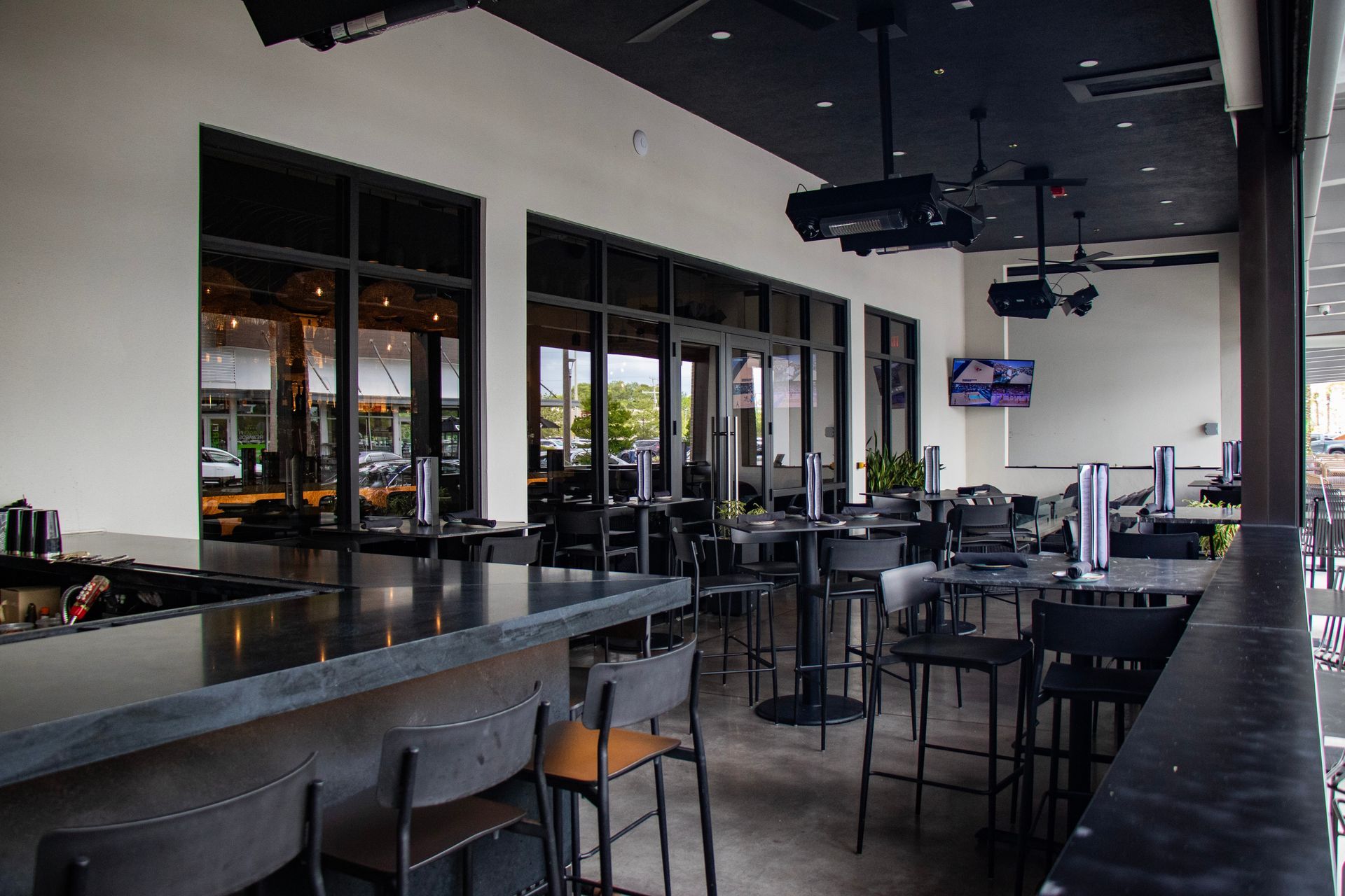 A restaurant with tables and chairs and a large window