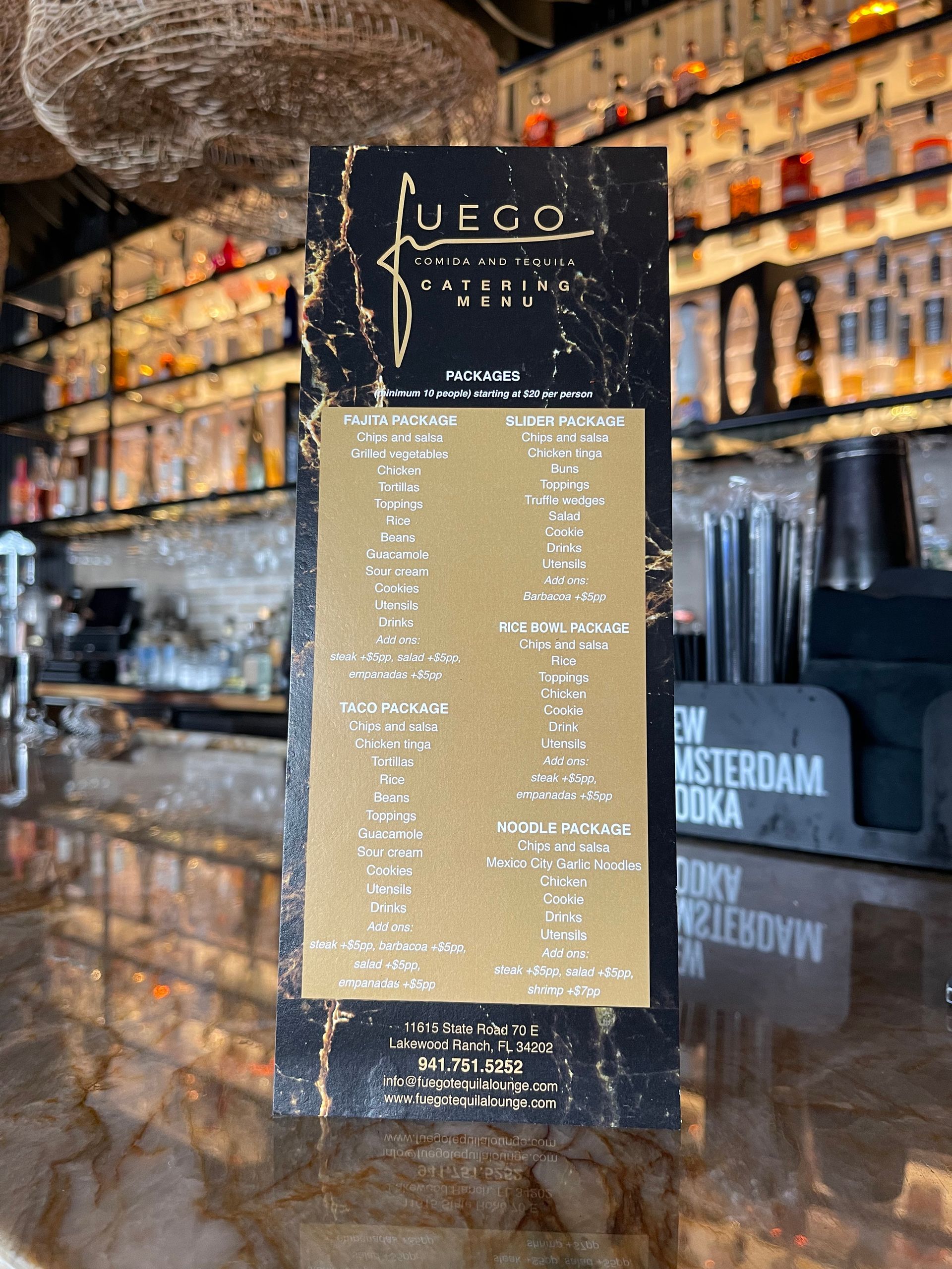 A menu is displayed on a counter in a restaurant