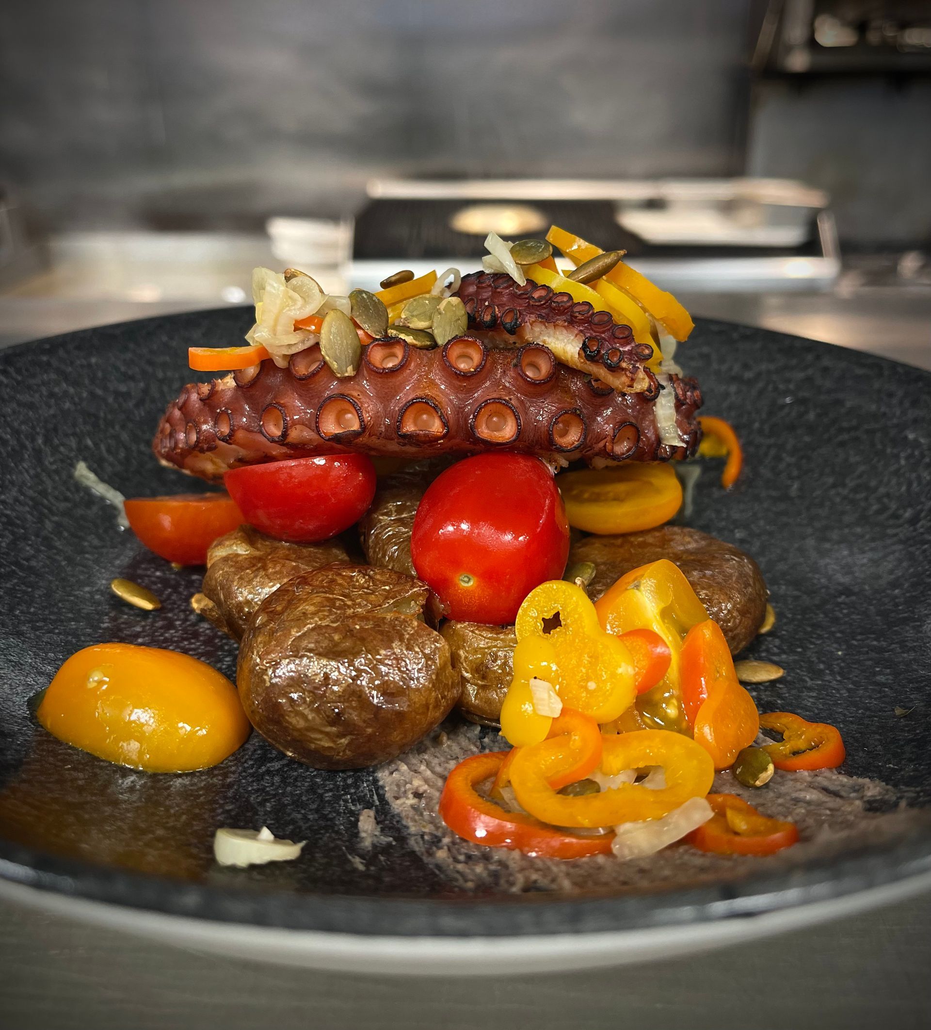 A close up of a plate of food with an octopus on top