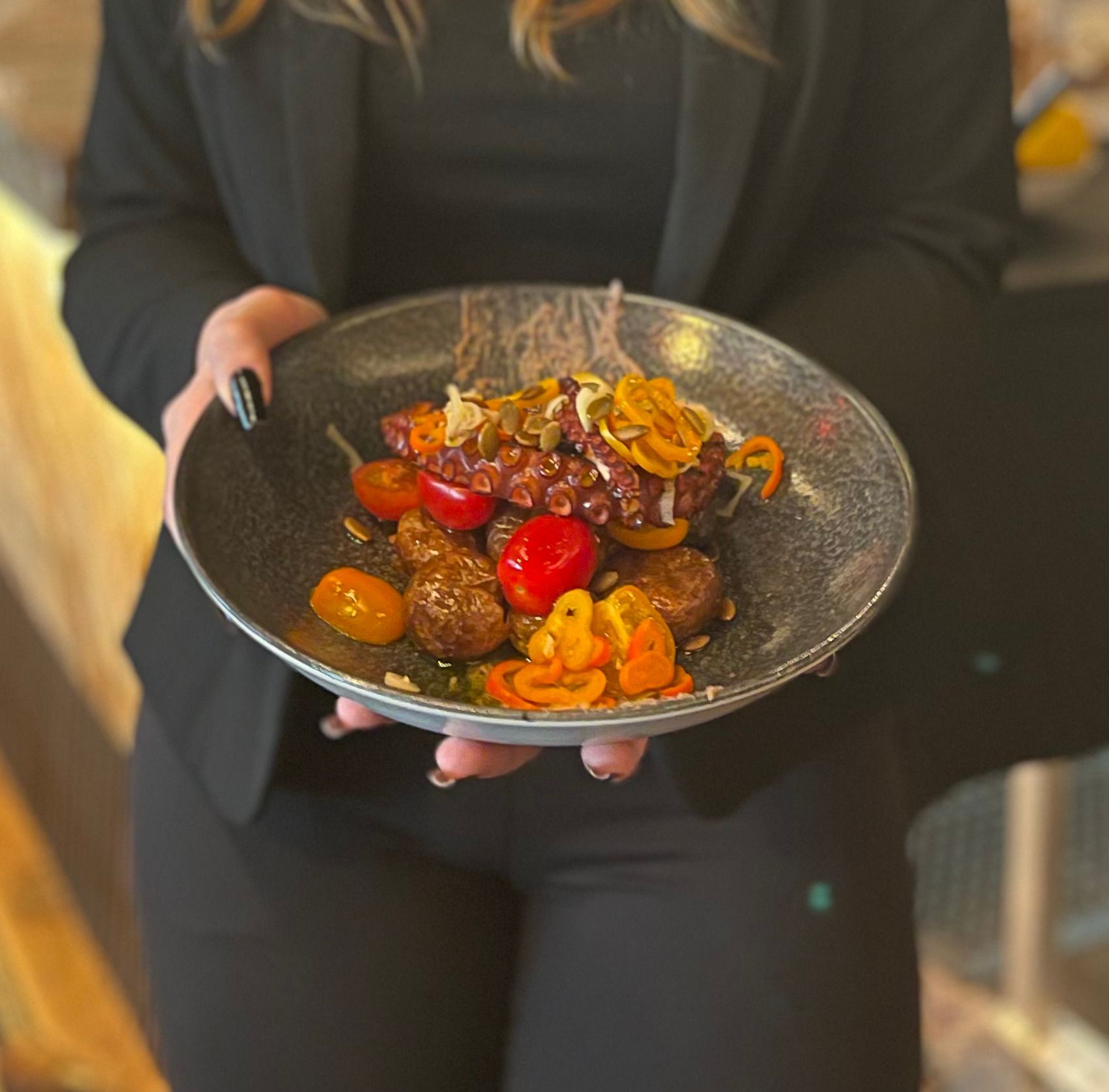 A woman is holding a plate of food in her hands.