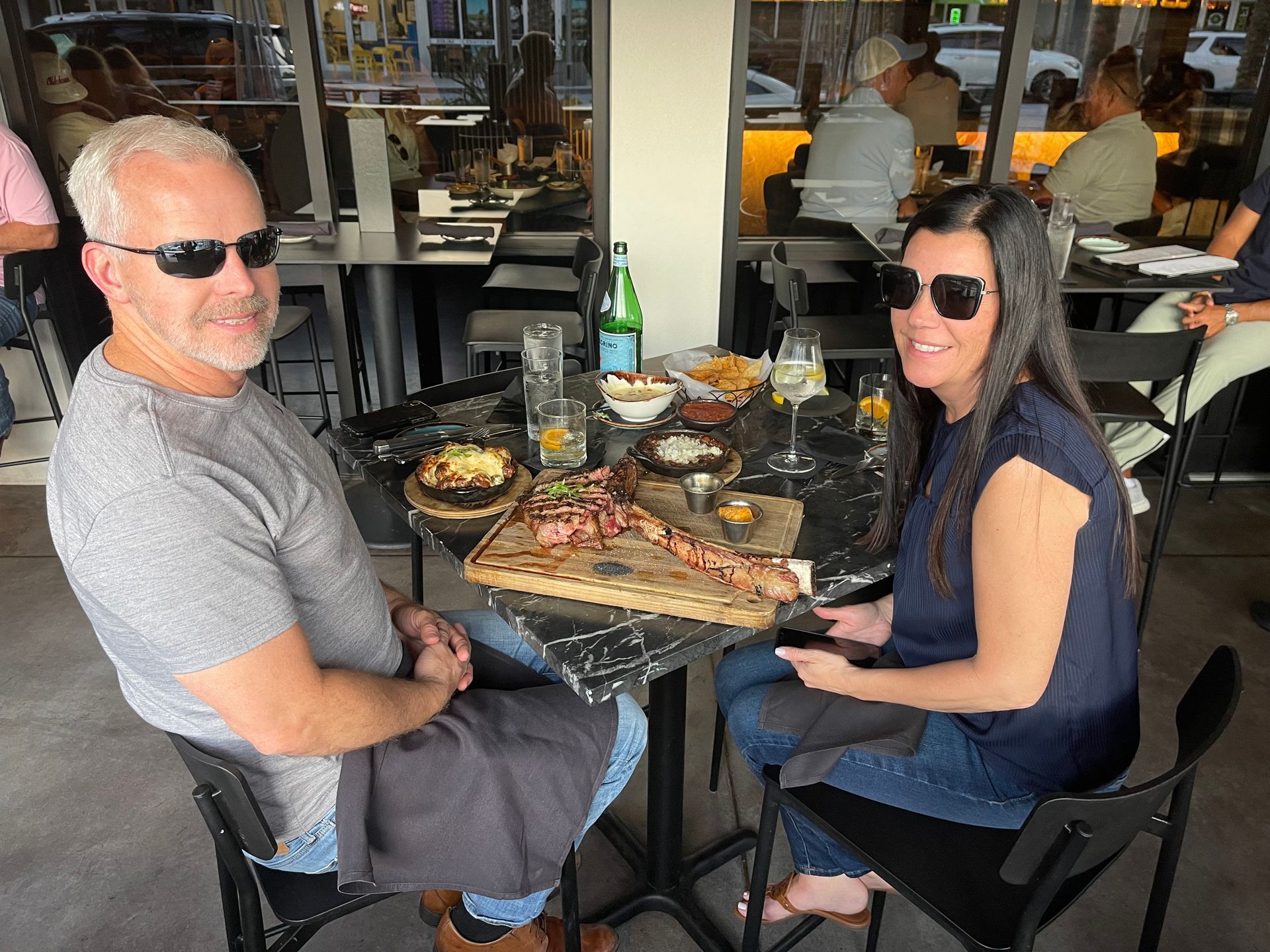 A man and a woman are sitting at a table in a restaurant.