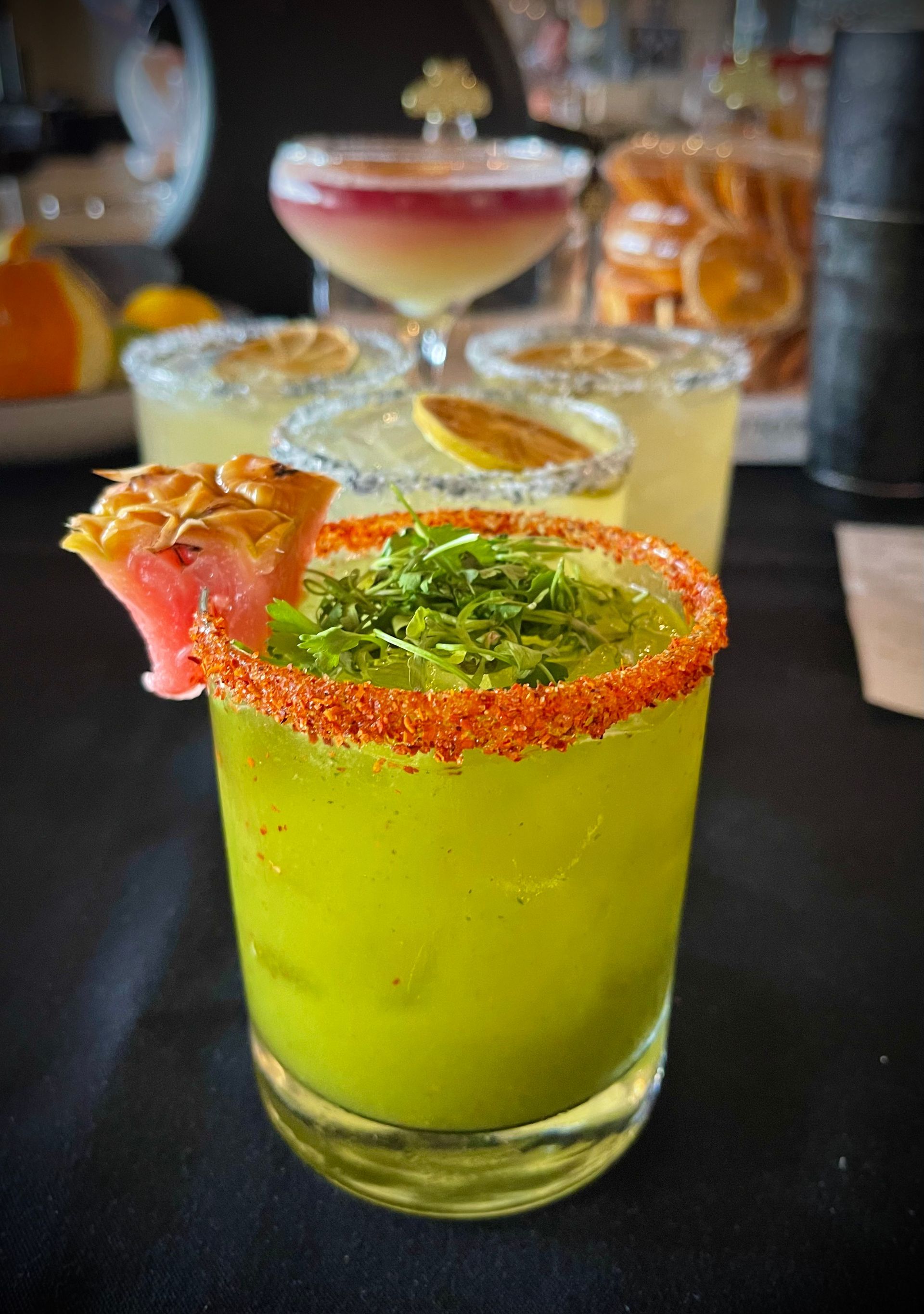 A close up of a margarita in a glass on a table.
