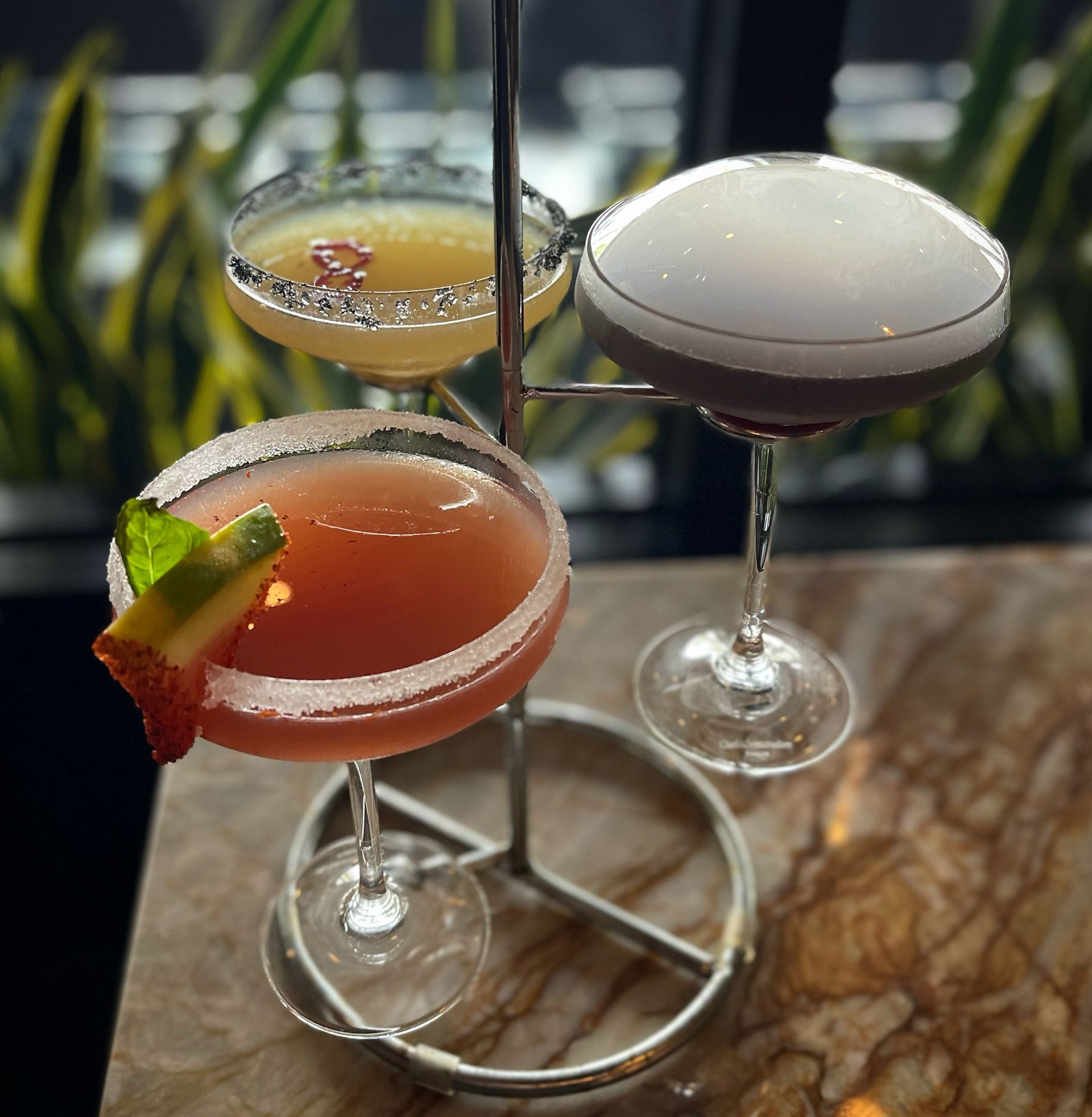 Three martini glasses are stacked on top of each other on a table