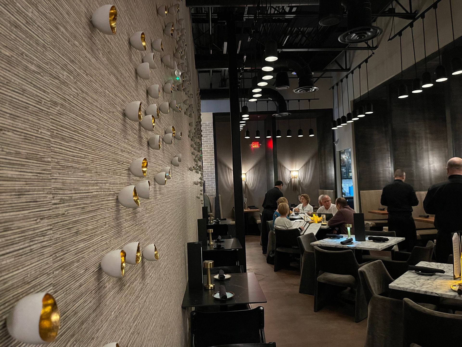 A group of people are sitting at tables in a restaurant
