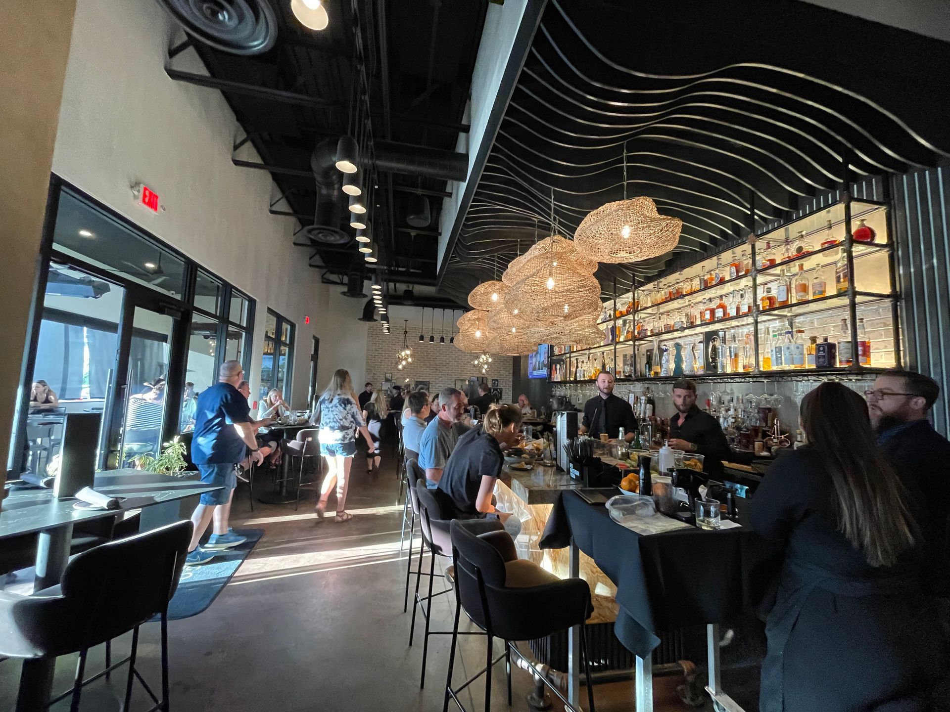 A group of people are sitting at tables in a restaurant.