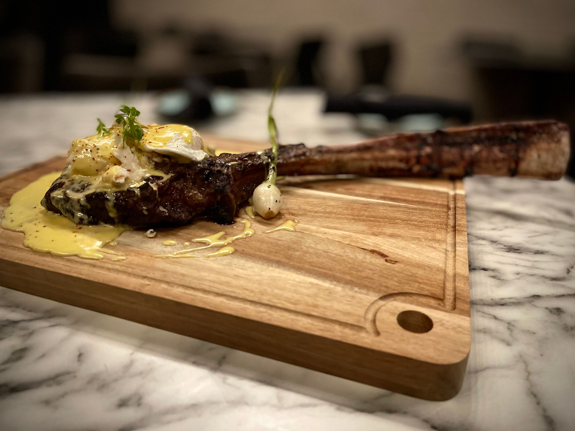 A wooden cutting board with a piece of meat on it.