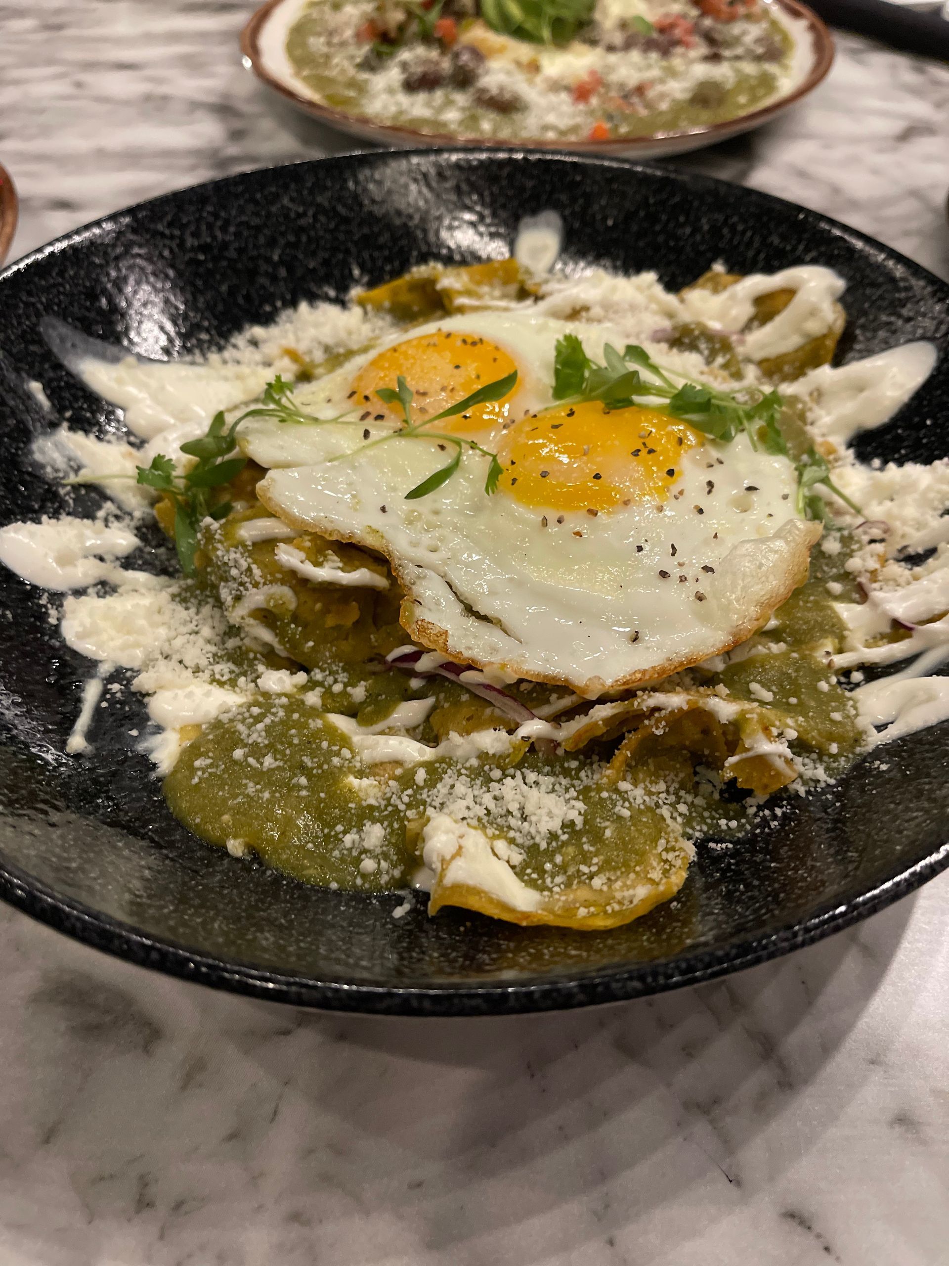 A close up of a plate of food with eggs on top