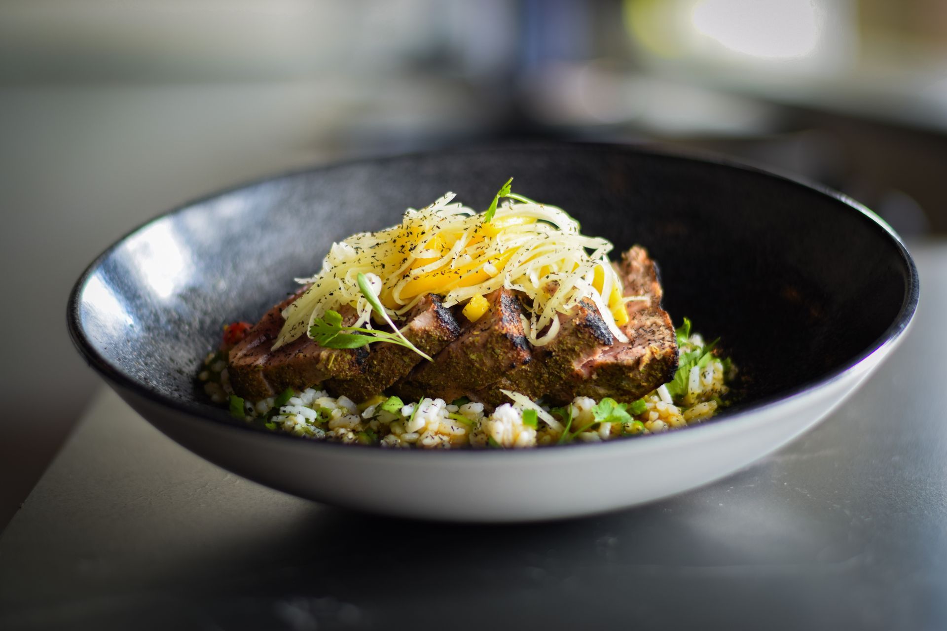 A close up of a bowl of food on a table.