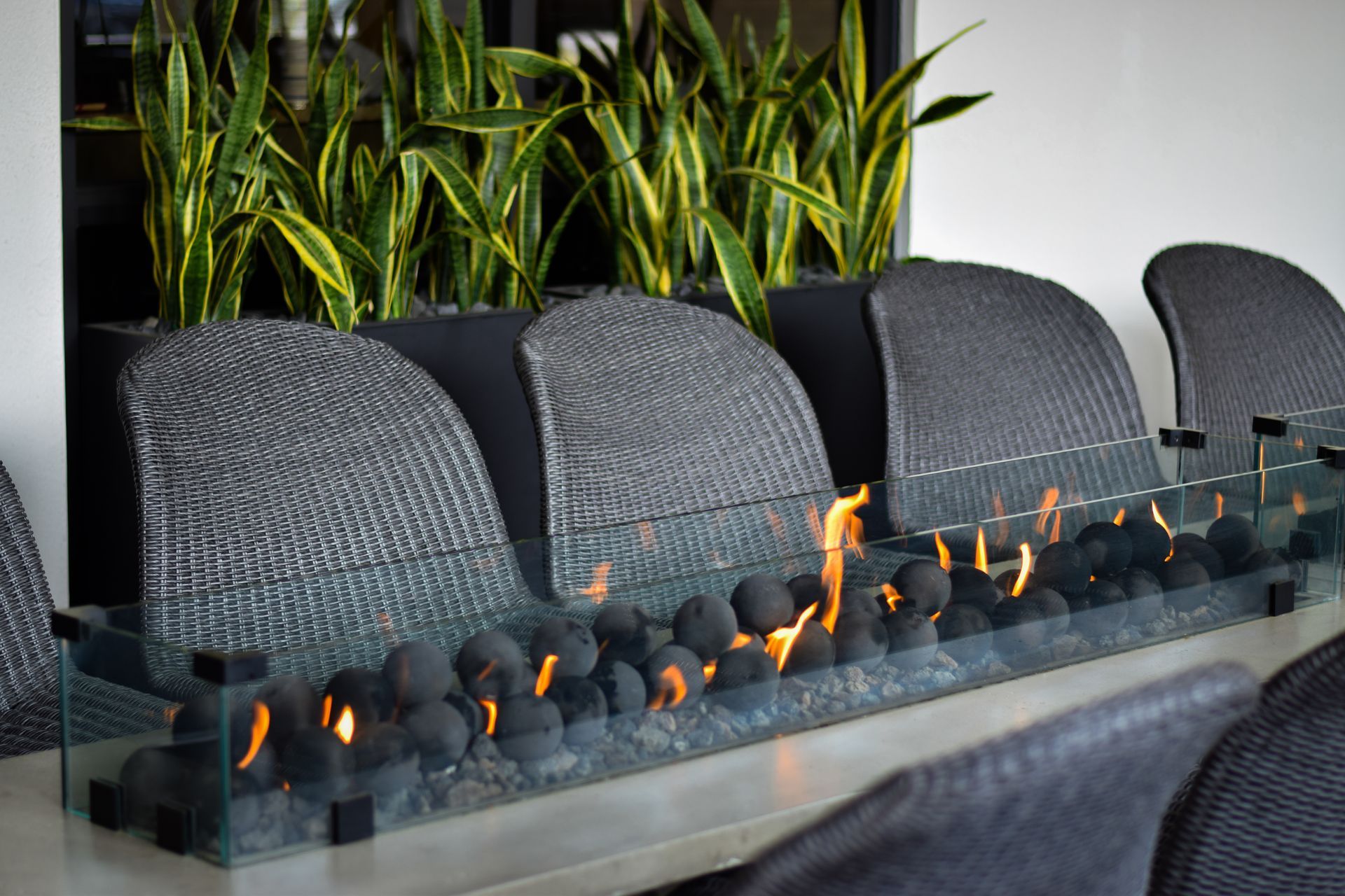 A dining room table with a fire pit and chairs