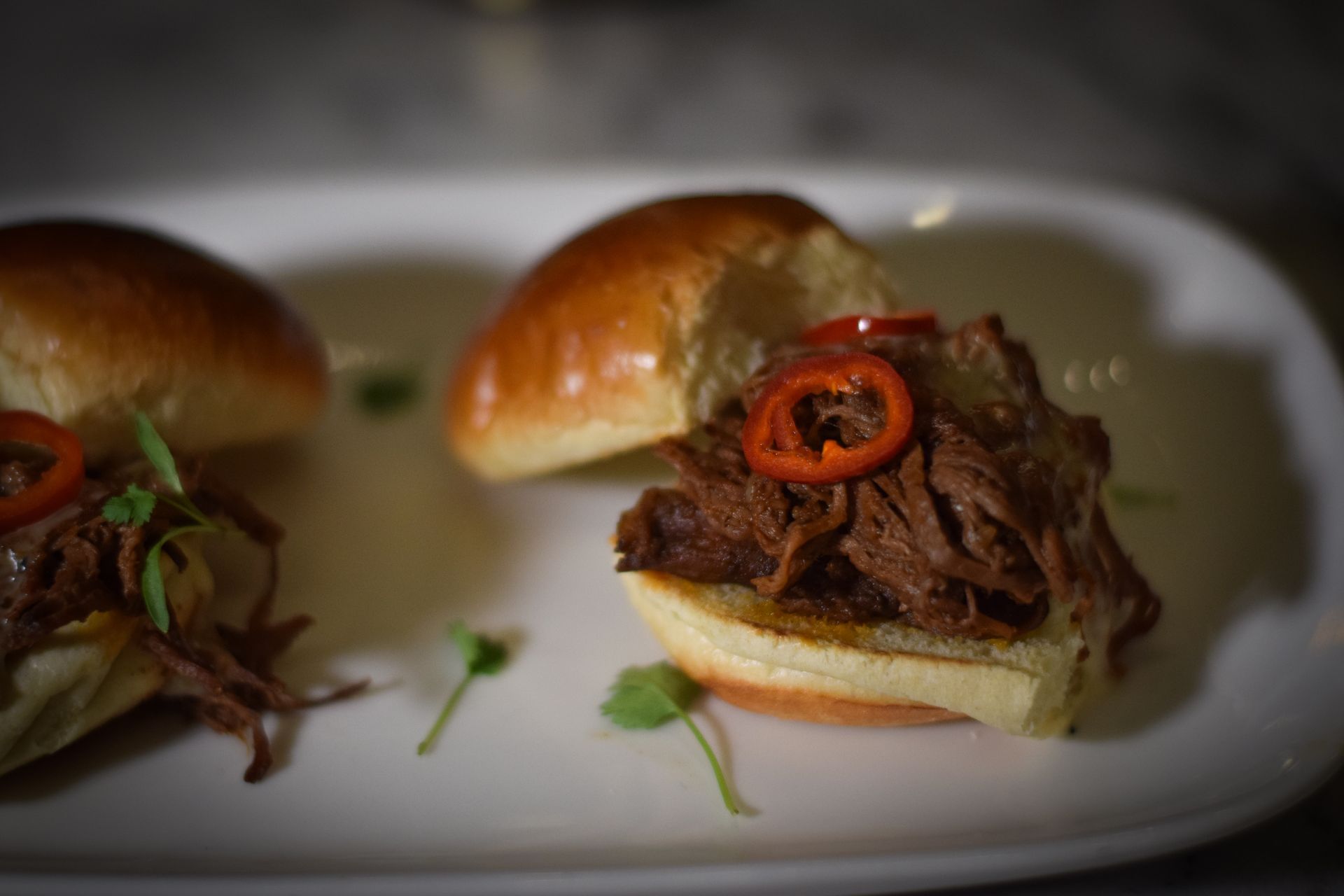 A close up of a plate of food with a sandwich on it.