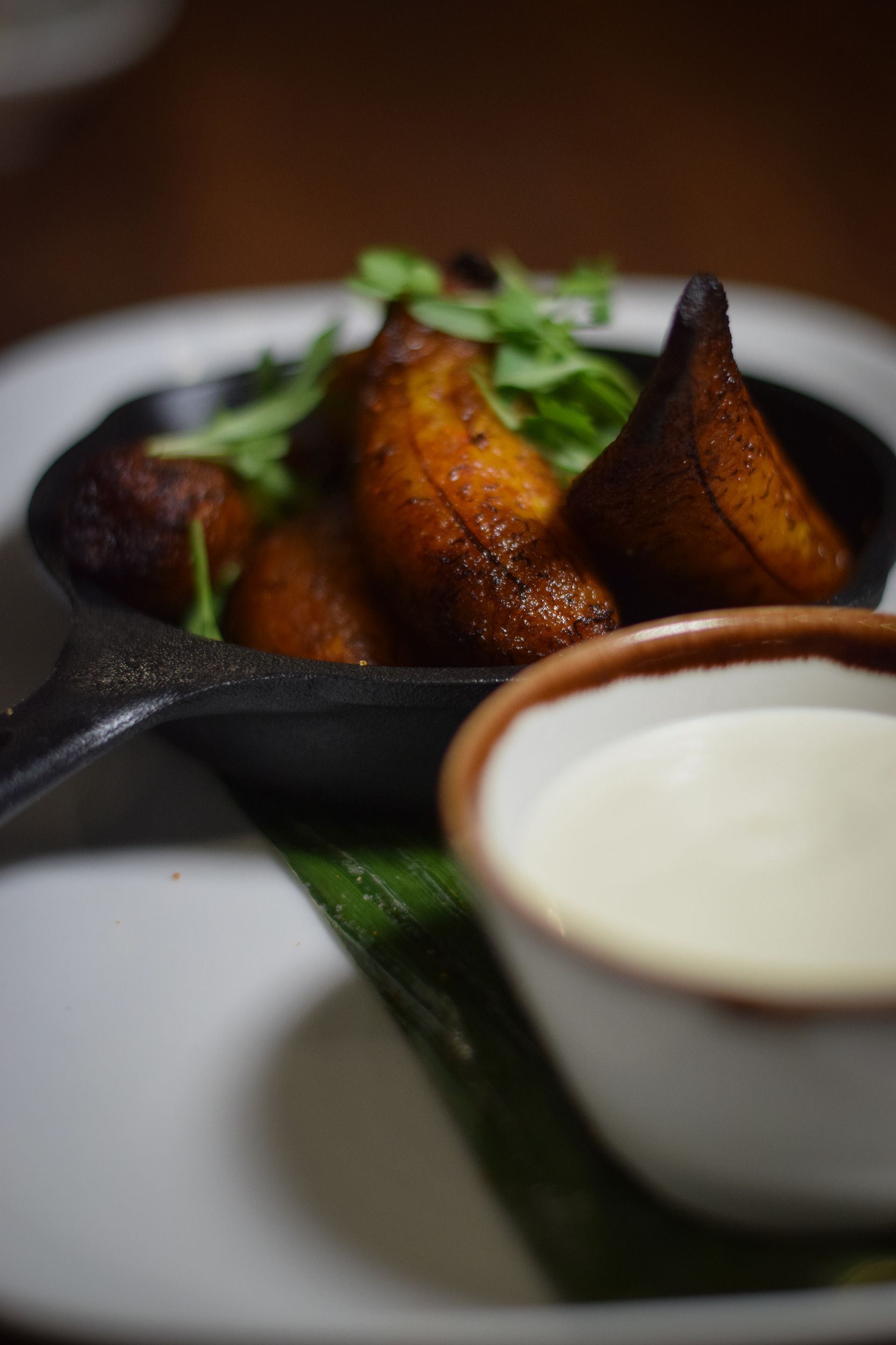 A close up of a plate of food with a bowl of dipping sauce