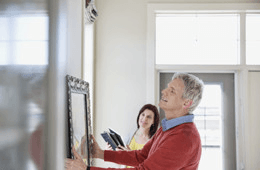 Man checking photo frame
