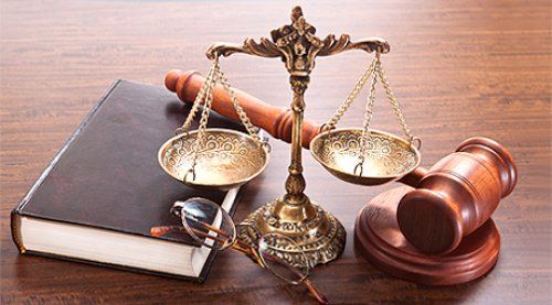 Scales of justice and a gavel along with a law book
