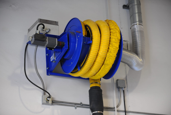 A blue and yellow hose reel mounted on a white wall, with a black hose extending downwards and a silver exhaust pipe.