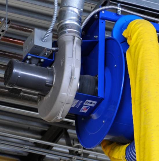 Blue and silver dust collection system mounted on a ceiling, with a yellow flexible hose being handled.