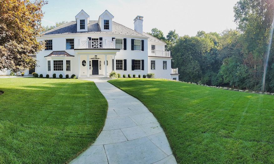 A large white house with a walkway leading to it