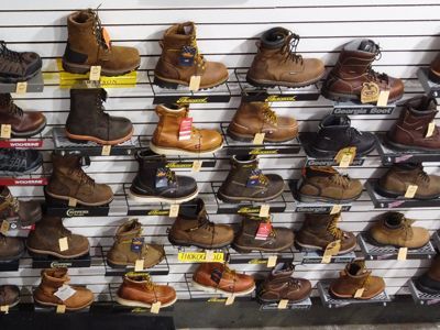 A wall filled with lots of different types of boots