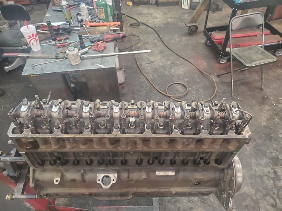 A car engine is being worked on in a garage.