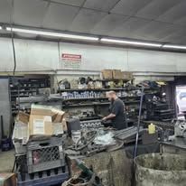 A man is working on a machine in a garage.