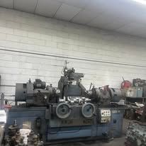 A machine is sitting in a garage next to a brick wall.