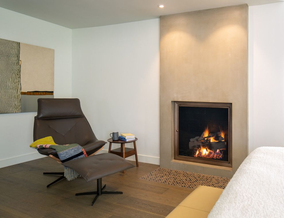 Modern living room with brown lounge chair and lit fireplace