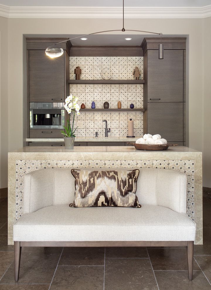 Modern spa nook with built-in coffee bar, patterned countertop, and cream bench with a decorative pillow