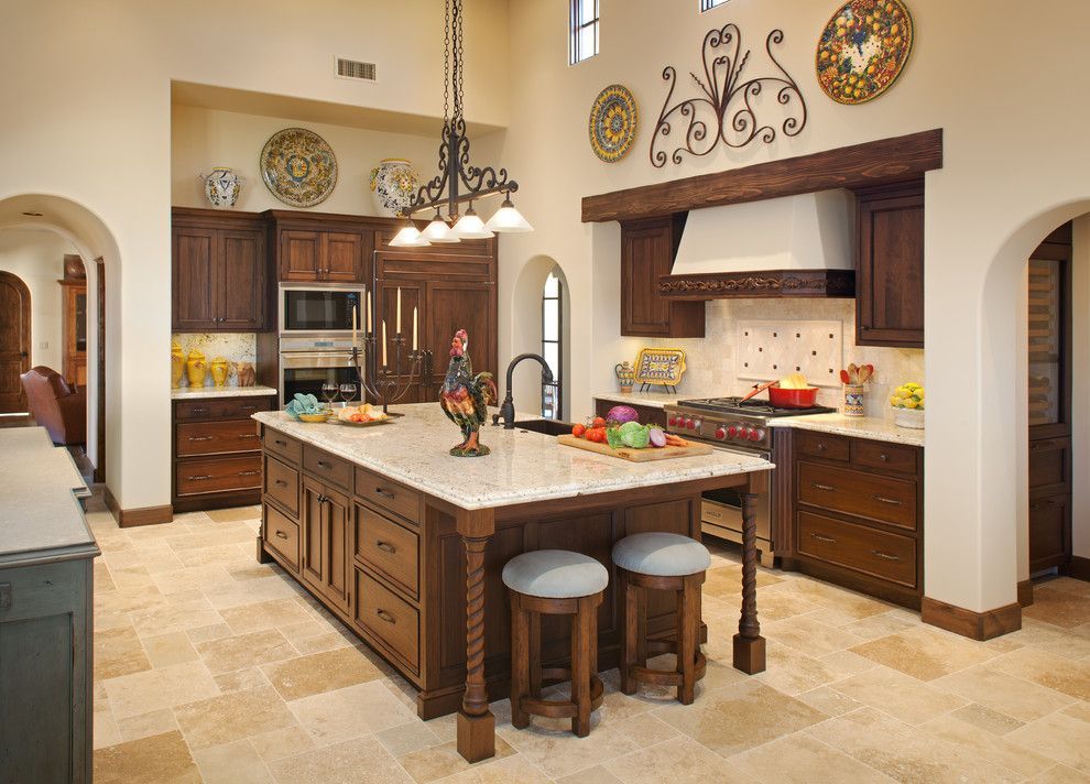 Spacious modern kitchen with a large island, wood cabinets, stainless appliances, and warm beige tile flooring