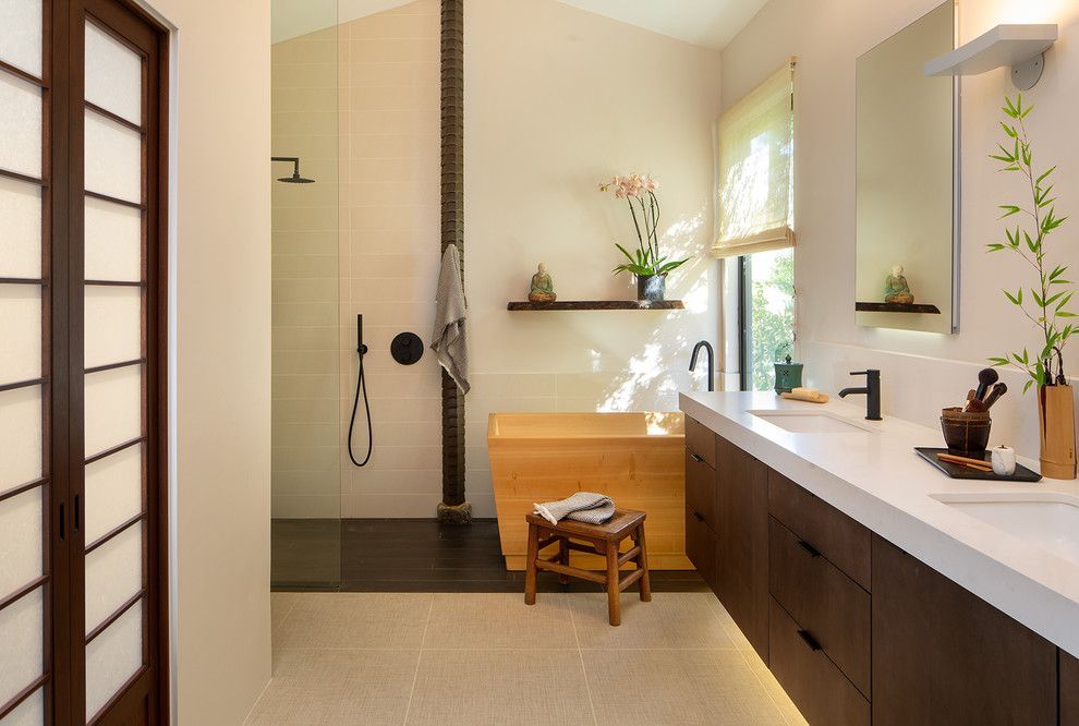 Modern bathroom with a freestanding tub, walk-in shower, vanity, and large window
