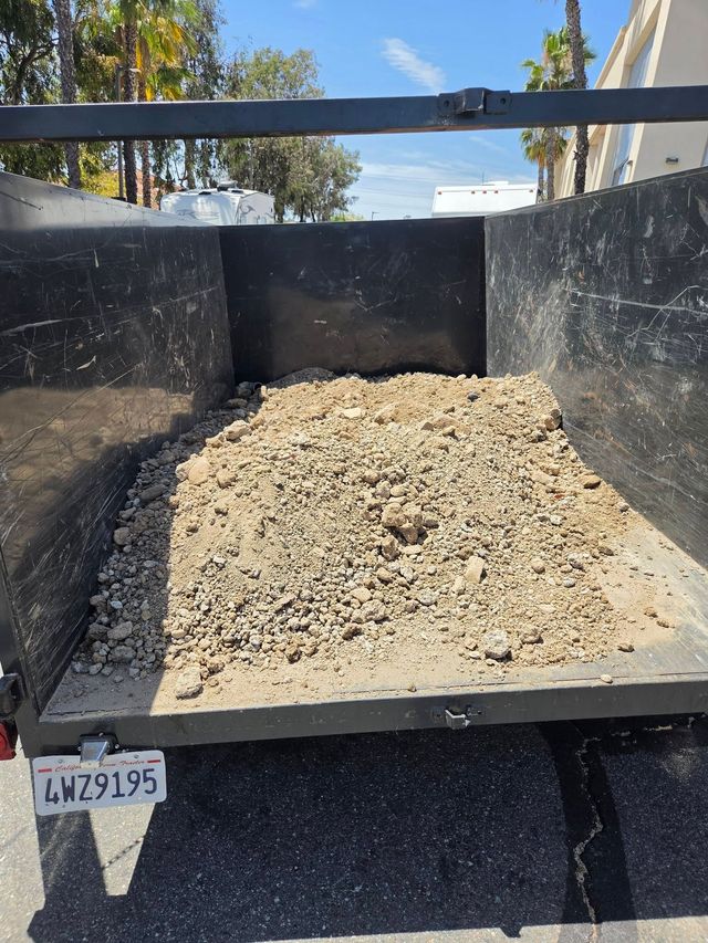 Dump trailer filled with gravel on a sunny day