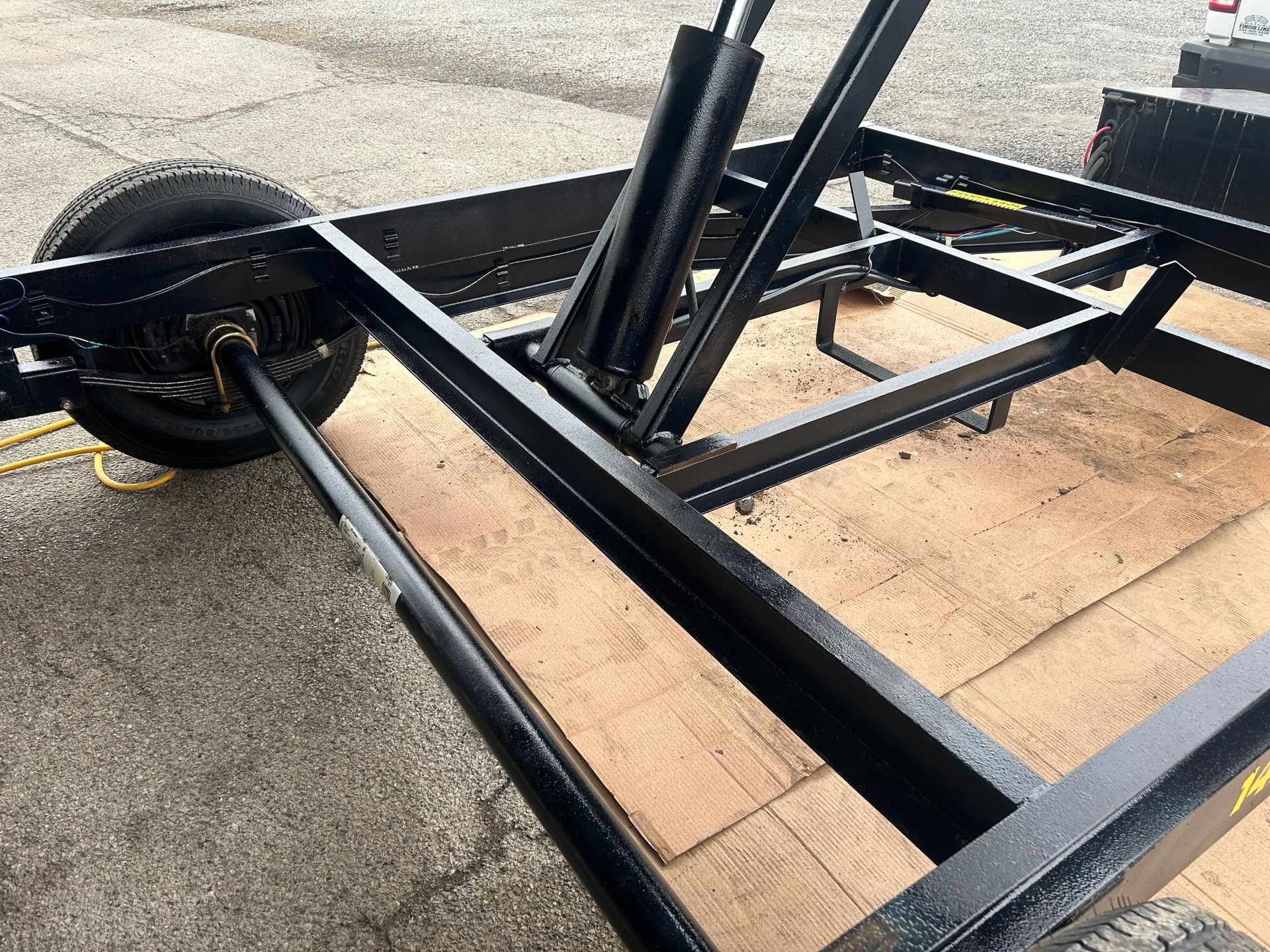 A trailer is sitting on top of a wooden floor.