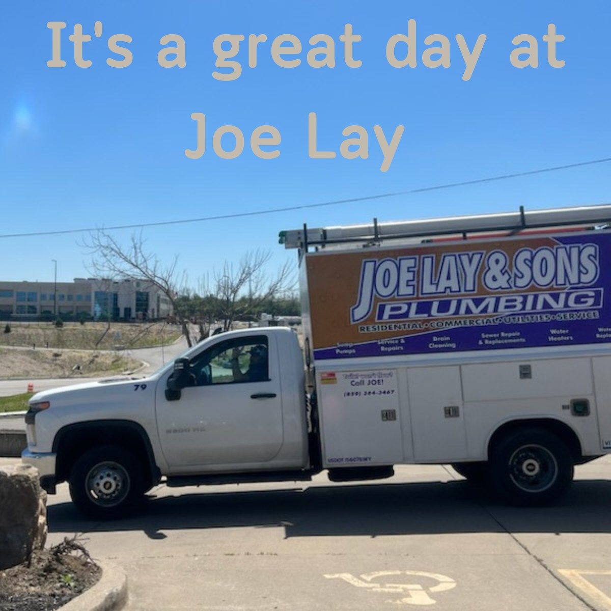 Joe Lay & Sons Plumbing truck parked outside on a sunny day.