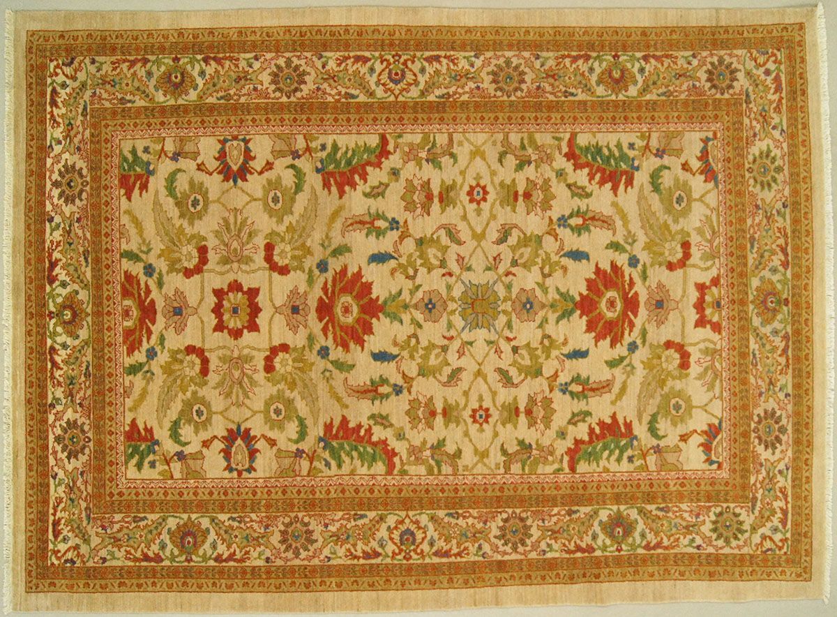 Beige rectangular rug with floral and geometric designs in shades of red, green, and brown