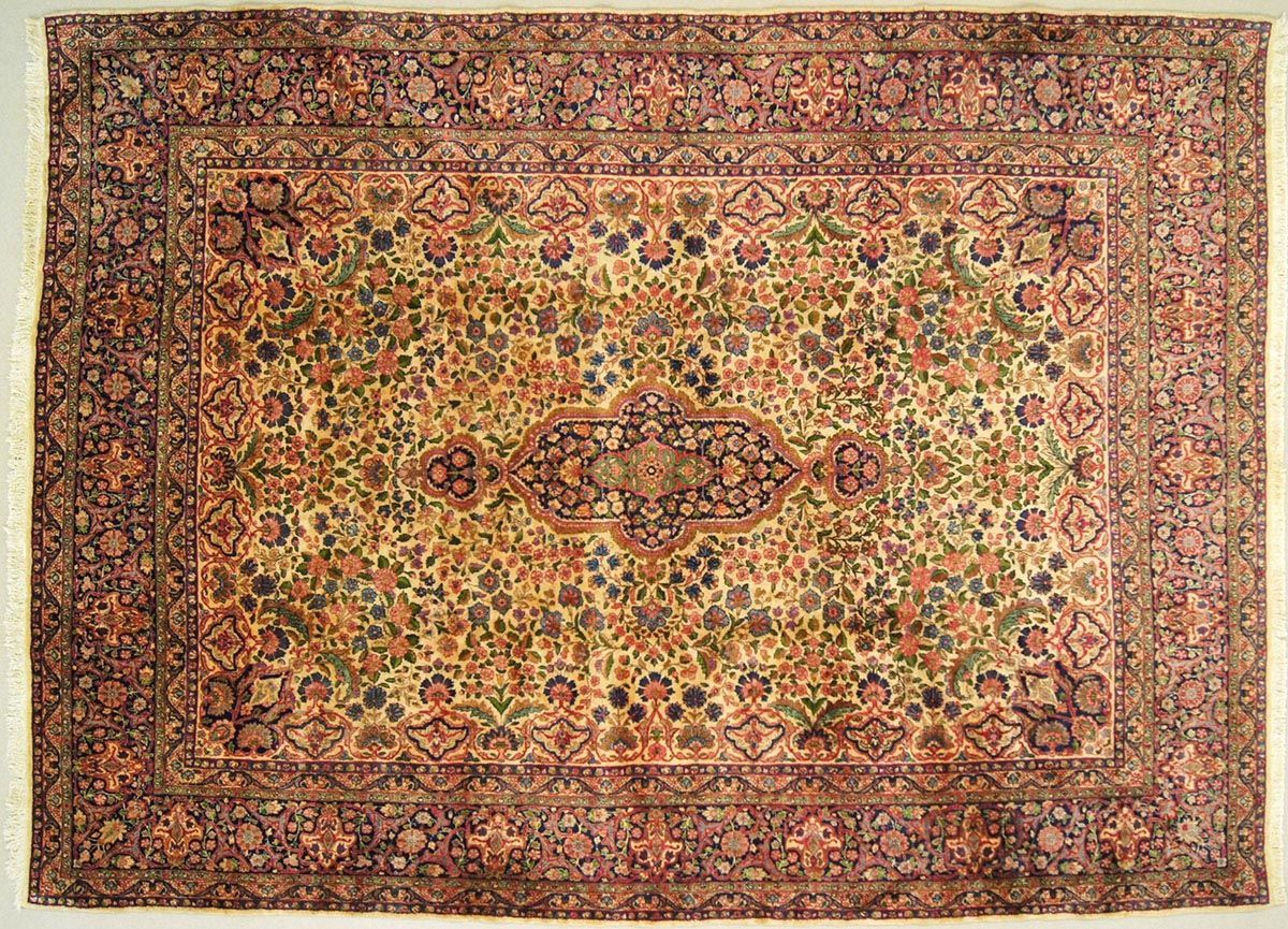 Intricate, floral patterned oriental rug in beige, green, and burgundy hues, with a central medallion