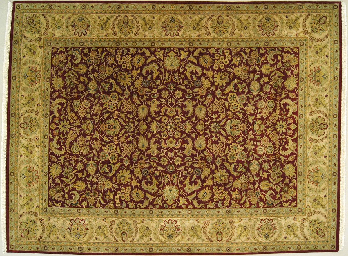 Oriental rug with a maroon center and an ivory border featuring floral patterns